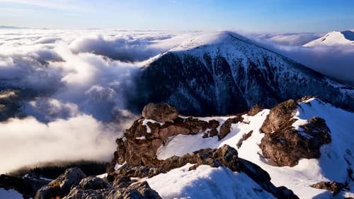 Time Lapse Shot of Clouds Below Mountain Peak in Winter Shortly After Sunrise