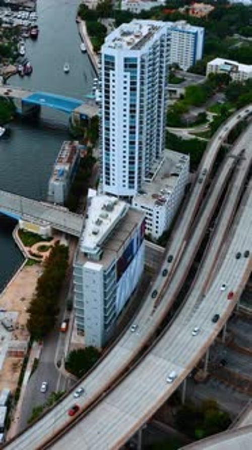Rising above the ramified highway going along the narrow river in downtown. View of Miami, Florida