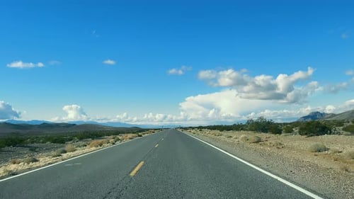 Desert Journey Road Through Arid Mountains An Empty Road Leading Through a Serene Desert Landscape