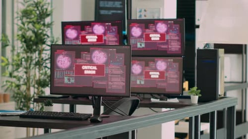 Empty Agency Office with Multiple Monitors Showing System Crash Warning