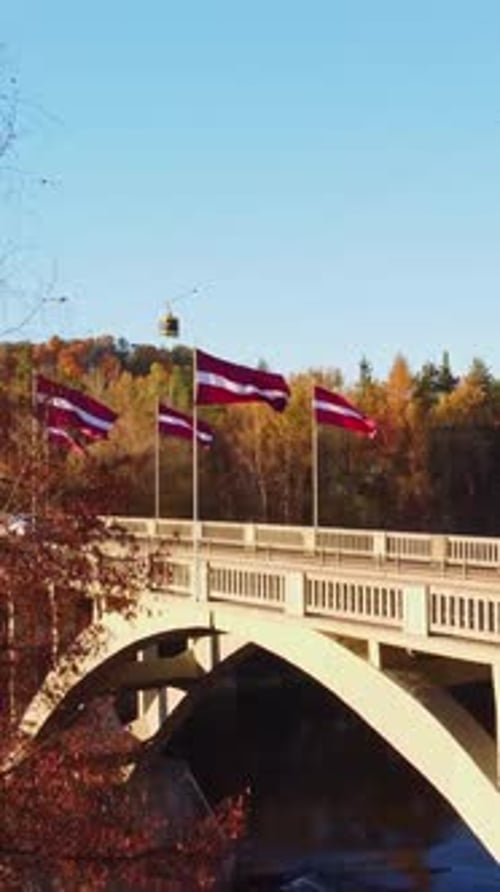 Latvian Flags_Vertical Crane Shot Over Sigulda Bridge