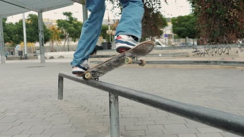 Young Skater Making 360 Flip Jump Performing Kickflip Trick Skateboarder Training in Skatepark