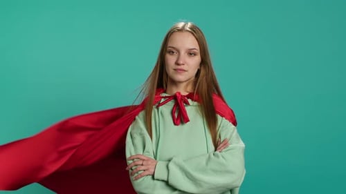 Happy Young Girl Portraying Superhero Flying with Cape Fluttering in Wind