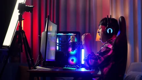 Asian Boy Streamer Celebrating Winning Game On Computer. Live Stream Video Game