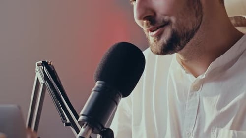 Man Speaking Into Microphone in Recording Studio