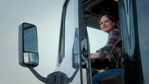 A Professional Woman Trucker Stands in a Semi Truck Close Up Shot Footage