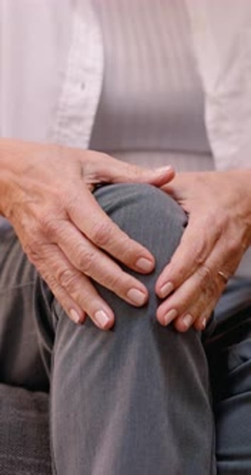 Woman Massaging Knee in Close Up Shot
