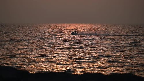 Jetski rider during sunset in Dubai, Plam Jumeriah, United Arab Emirates. 4k Footage