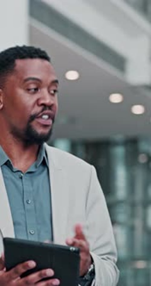 Man in Suit Uses Tablet in Office