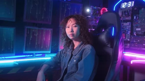 an asian woman programmer is working in her computer room