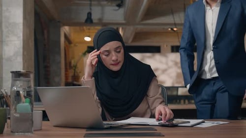Office Business Team Man Helping Woman with Laptop Software Difficulties Two Arabian Colleagues