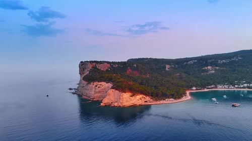 Beautiful rocks covered with green woods at the shore of the Mediterranean Sea. Coast of Turkey