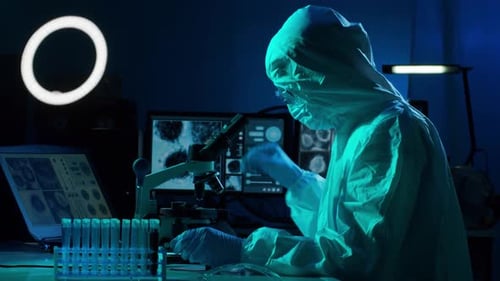 Scientist Working in a Lab Using a Microscope