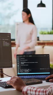 Vertical Video Male Coder Works From Home Typing Code on a Laptop in a ...