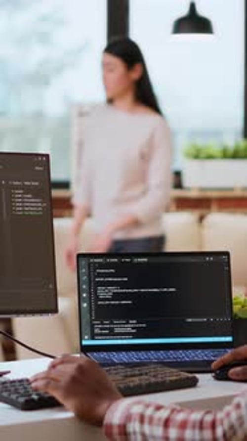 Vertical Video Male Coder Works From Home Typing Code on a Laptop in a Modern Living Room