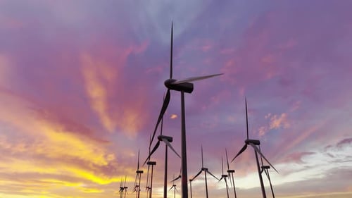 Working Wind Turbines on a Wind Power Plant on the Backdrop of a Beautiful Sunset Sky Concept of