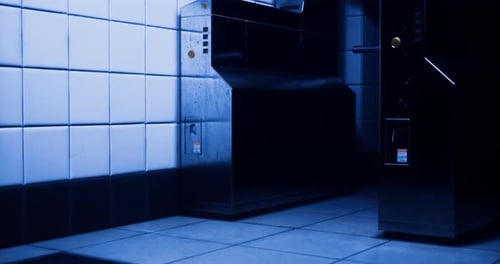 Futuristic Blue Lit Industrial Hallway with Machines Animation