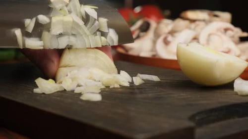 Dicing Onions with a Knife on Cutting Board