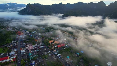 Drones are flying over the misty covered city of Phang Nga