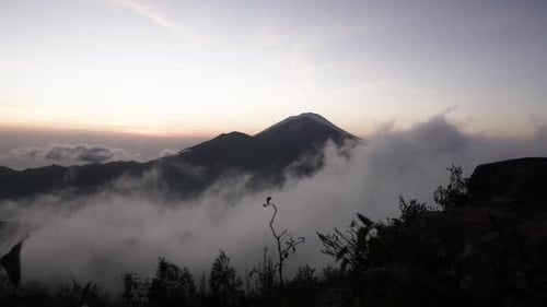 Mountain silhouette and floating thin clouds in the early morning before sunrise, time lapse scenic