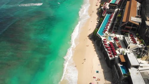Top Aerial View on Sandy Ocean Shore with Resting Tourists and Beach Umbrellas Turquoise Water in