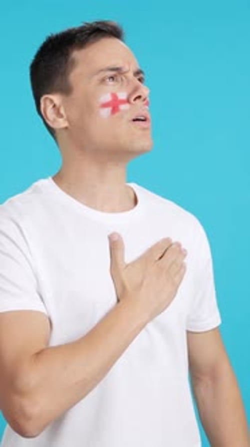 Man with Face Paint Puts Hand Over Heart