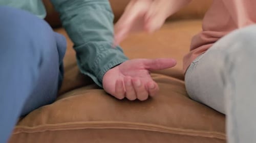 Close up of Holding Hands of Young Couple