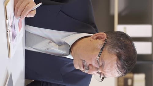 Vertical video of Businessman working in the office.