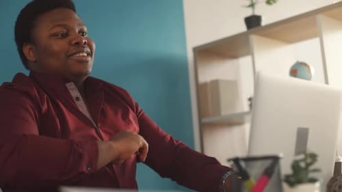 Smiling Young African American Man Working on Laptop Typing in Office Feel Happy Sunlight Business