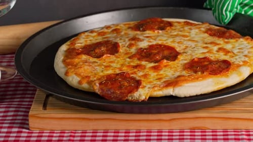 Pepperoni Pizza Fresh Out Of The Oven, Hand Places It On A Wooden Board