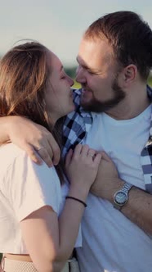 Man and Woman are Standing in the Field and Hugging Each Other Filmed in Closeup
