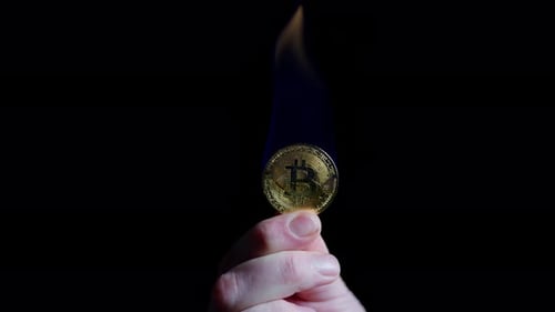 Hand Holds Burning Bitcoin Cryptocurrency
