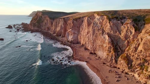 4K Golden Hour Light Colored Coastal Cliffs Aerial