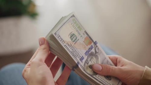 Woman Counting Stack of Cash Money Indoors