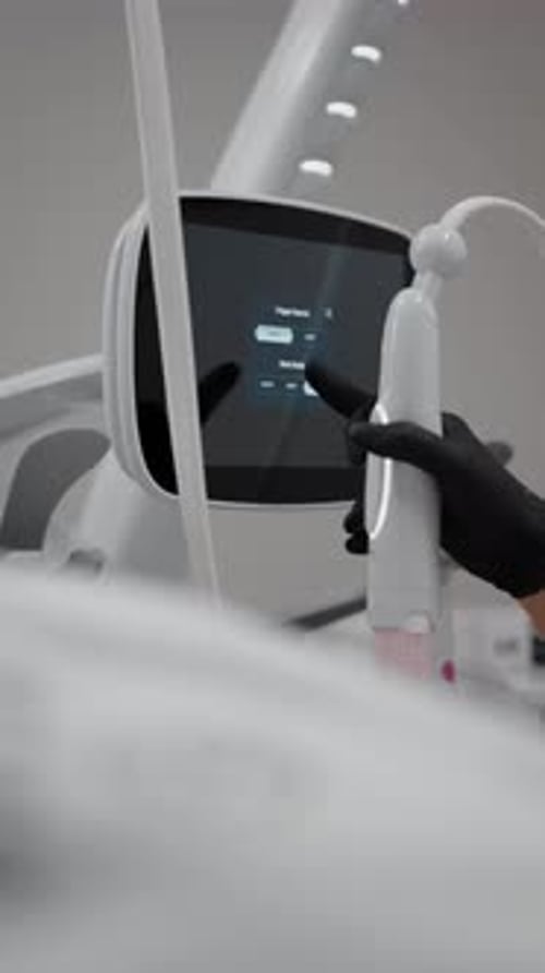 Professional Operating a High-Tech Medical Device Touchscreen