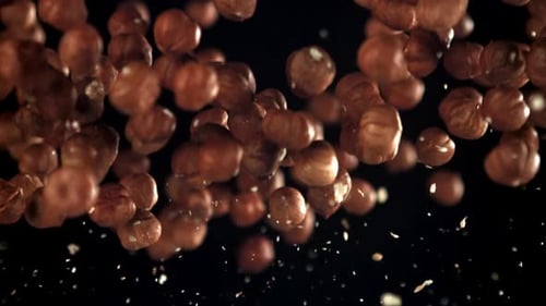 Hazelnuts Floating Dynamically on a Black Background