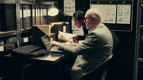 Colleagues Reviewing Files on Computer at Work