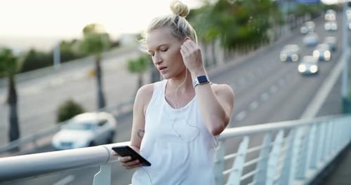 Earphones, fitness and woman with phone in city preparing for cardio race