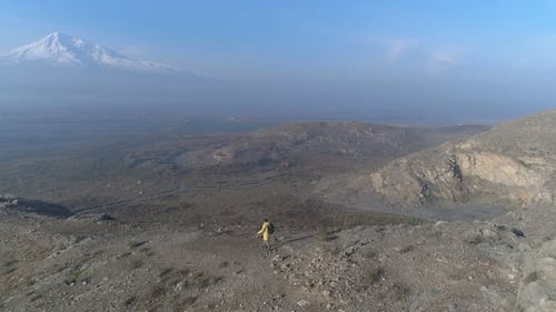 Backview Aero Shot: Guy Motion On The Way To The Peak And Looking At Cloudy Skyline. Cliff Ridge ...