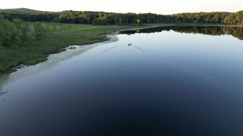 Small boat in Remote lake Aerial video sunset