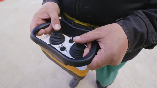Man Operates with Joysticks of Remote Controller Closeup