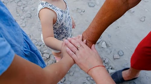 Family Generations Stacking Hands Together in Rural Setting