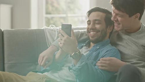 Affectionate Couple Laughing and Using a Mobile Phone