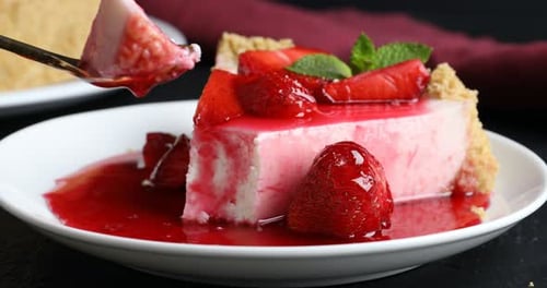 Strawberry cheesecake dessert with sauce and mint