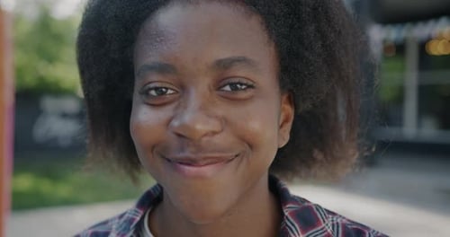 Closeup Portrait of Joyful Young African American Lady Smiling Looking at Camera Outdoors in City