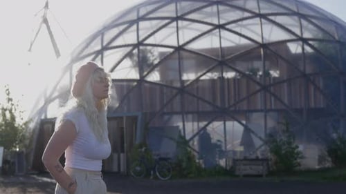 Woman Outdoors near a Dome-Shaped Modern Building
