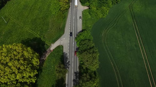 Car Driving Through Green Countryside Red Compact Car Moving Under Sunny Sky Top View Automobile