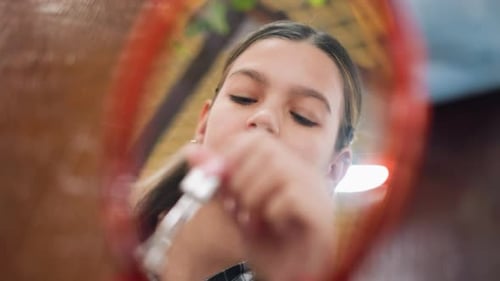 Teen Applies Serum to Her Face in Mirror