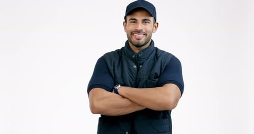 Happy man, delivery and arms crossed of professional in customer service against a grey studio