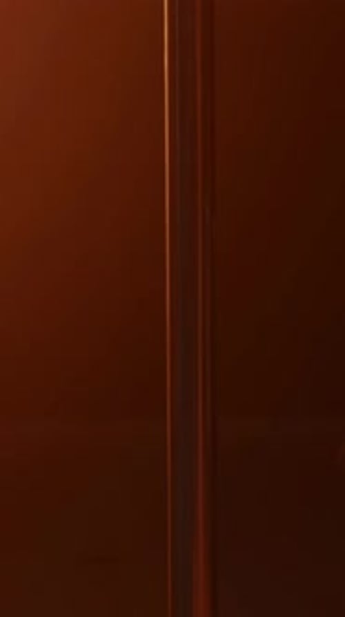 Vertical of Tall Pole on Floor at Dark Pole Dance Studio with Orange Light
